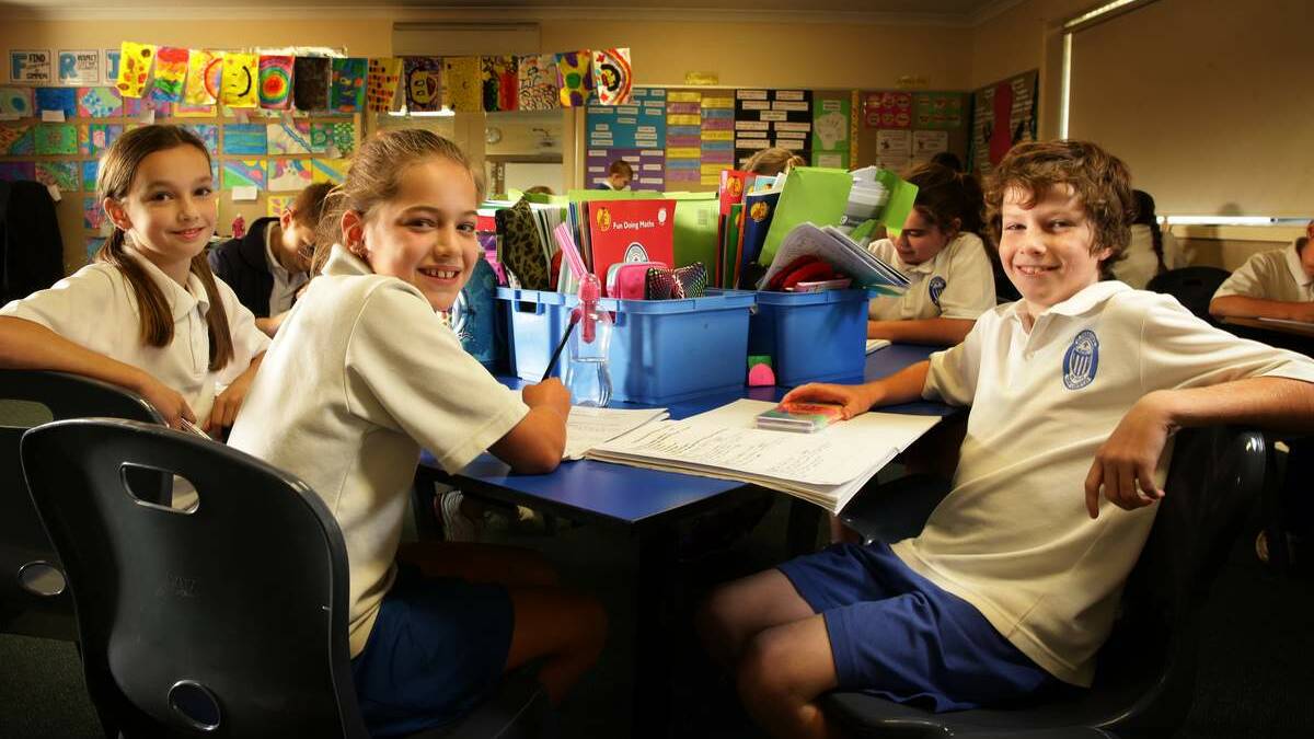 Year 5 students, left to right, Ellen Hughes, Abbey Anderson and Oliver Allen prepare for Naplan tests. Inset, principal of St Therese’s, Duilio Rufo. Picture: Peter Stoop