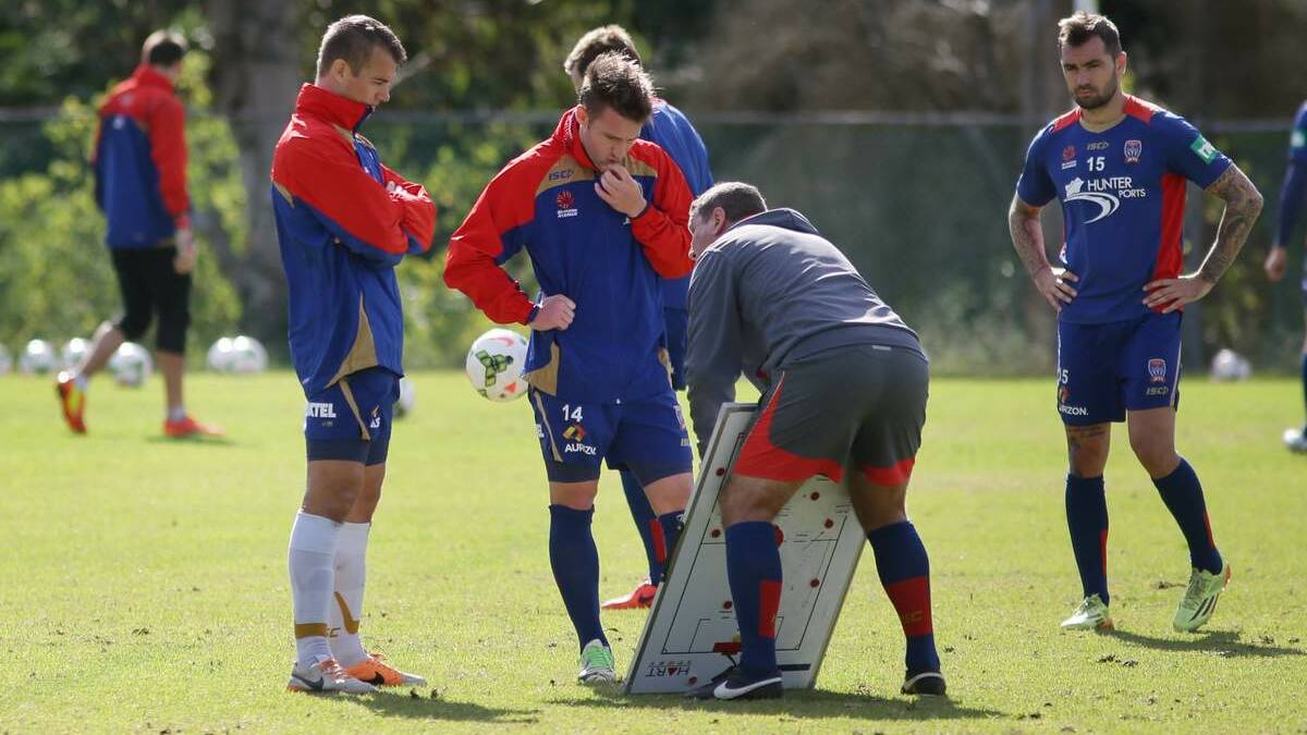 TALKING BUSINESS: Joel Griffiths and new signing Jeronimo Neumann with coach Phil Stubbins at Jets training yesterday.  Picture: Peter Stoop