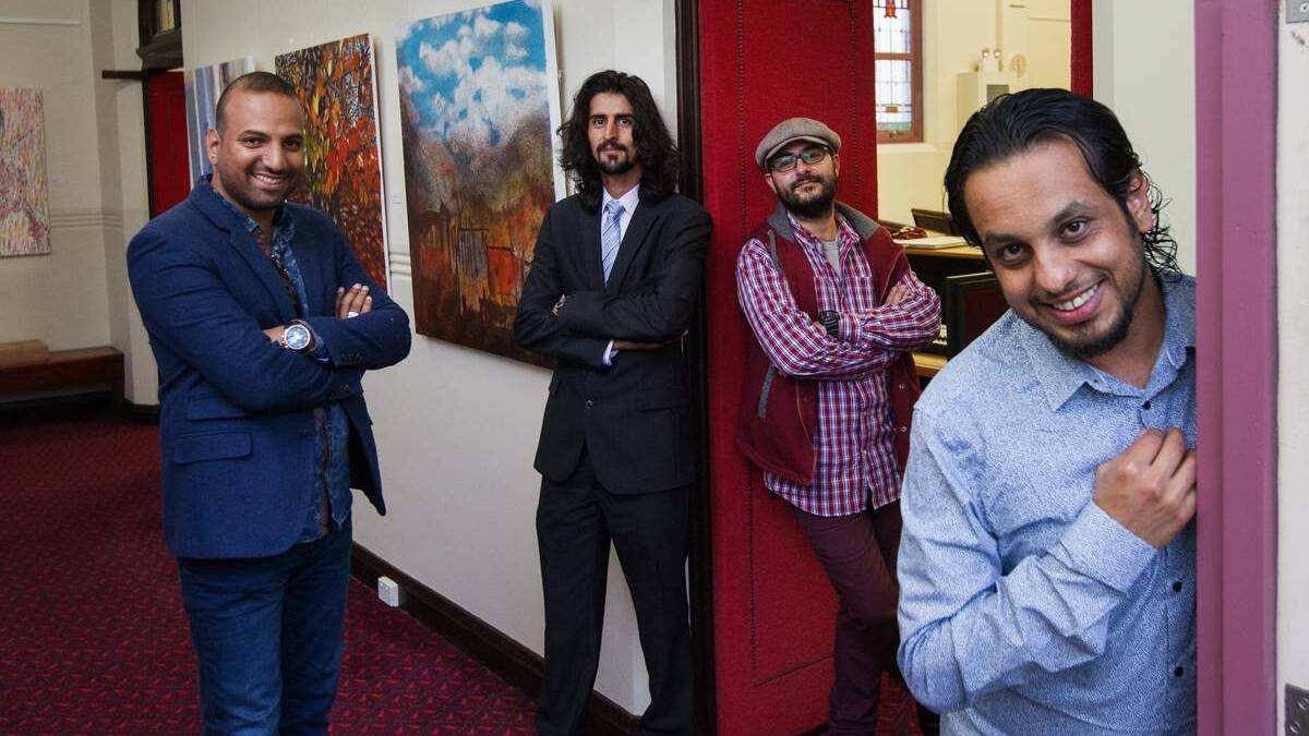 Syrian refugee artists from Sydney are showing their art works in an exhibition at Adamstown Uniting Church. Pictured L-R Hayder Albdairi, Mahdi Jahangirzadeh, Damon Amb, Mohammed Alanezi. Pictured with some of their works. Picture: Max Mason-Hubers
