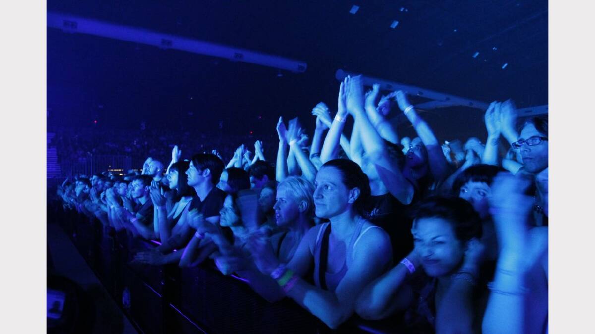 The crowd cheering for Nine Inch Nails, on stage at the Newcastle Entertainment Centre. NIN played with Queens of the Stone Age. Picture Max Mason-Hubers