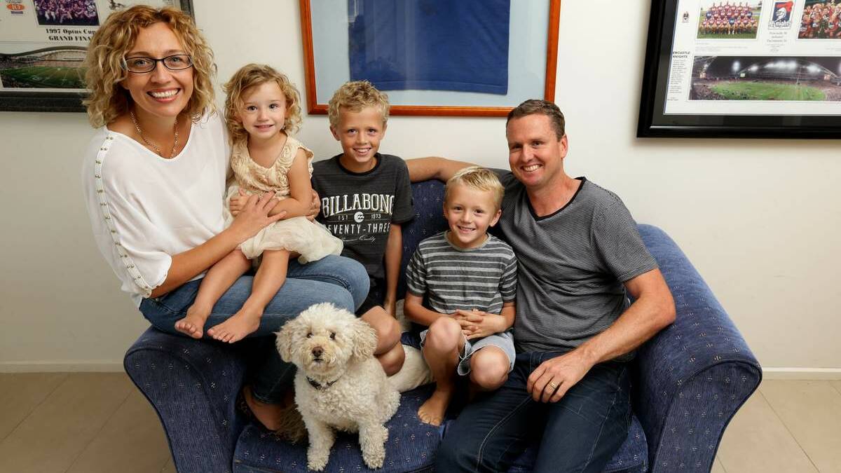 Former Knights player Mark Hughes at home with his family in Merewether. From left right, Kirralee with Bonnie, Dane, Zac and Mark. Honey the dog in front.
