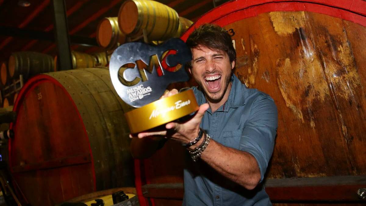 Morgan Evans, winner of the CMC Male Artist of the year, OZ Artist of the year and Australian Video of the year,  with his trophy on Friday night. 