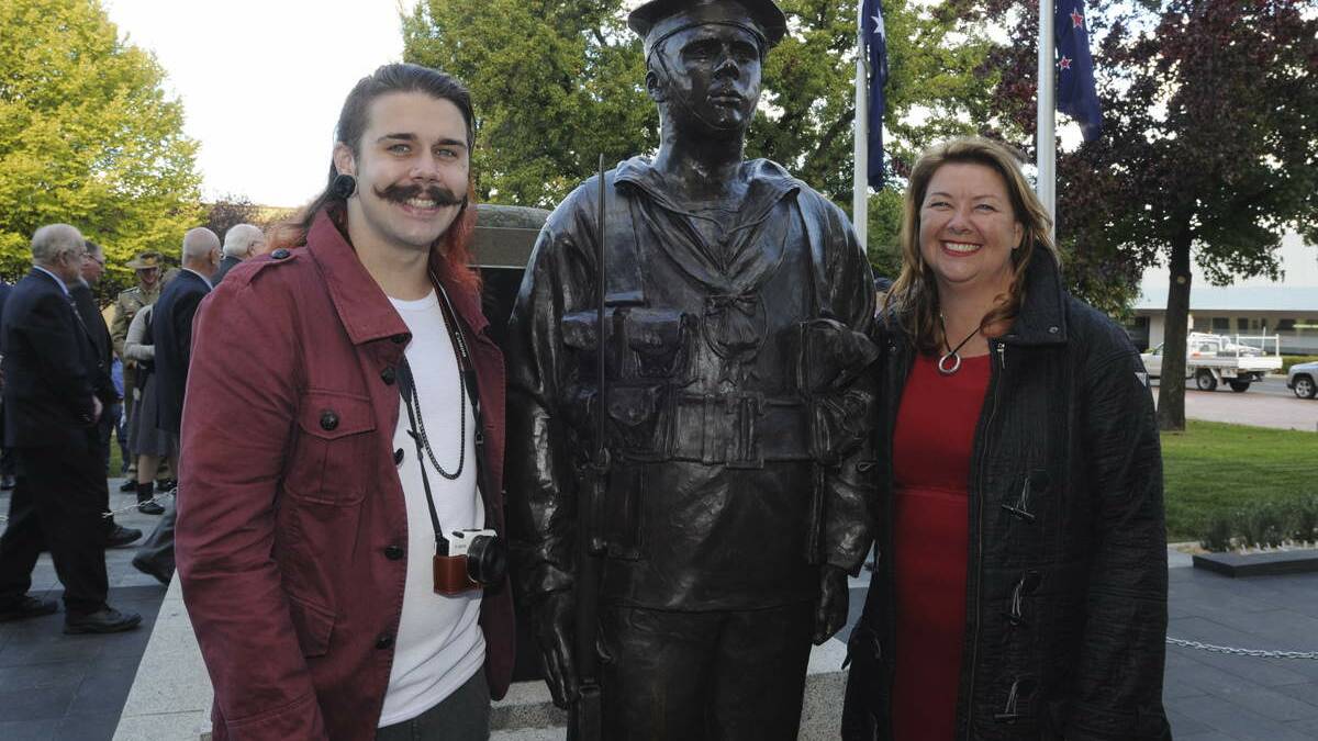  Newcastle artist Julie Squires (right) used her nephew Dane Squires (left) as the model for the bronze statue of a sailor that now stands at the western end of the cenotaph. Picture: Jude Keogh