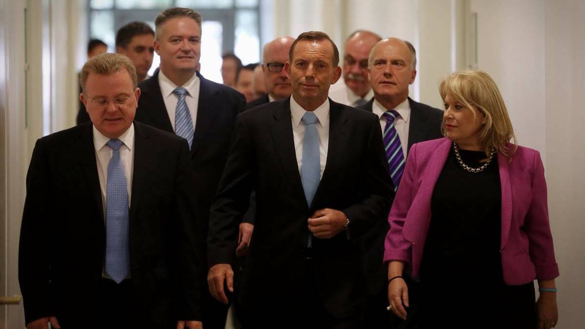 YES, PRIME MINSTER: Tony Abbott emerges from the Liberal party room after surviving a leadership spill on Monday.  Picture: Andrew Meares