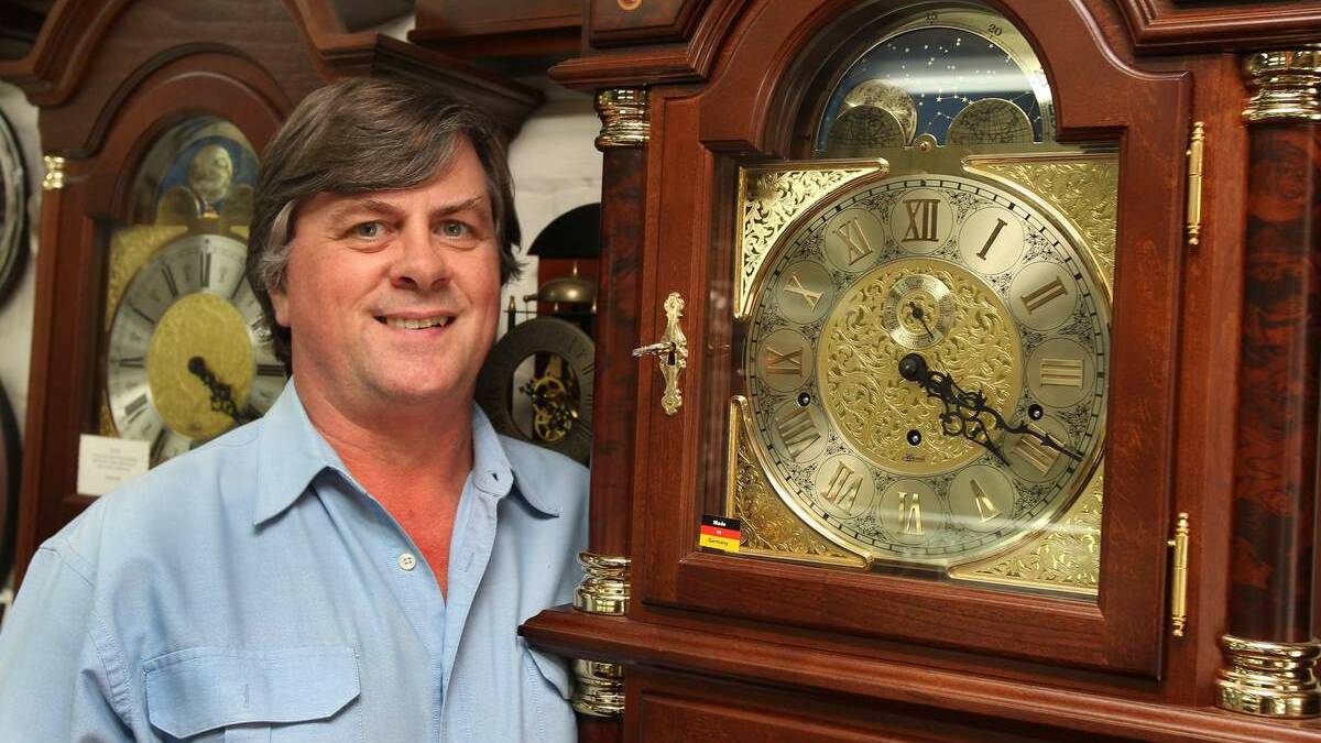 AVID HOROLOGIST: David Thomas admires a German grandfather clock.  Picture: Phil Hearne