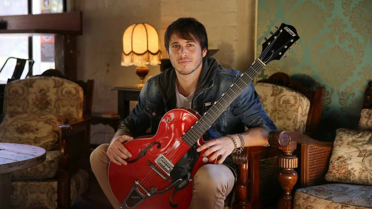 RARE REST: Morgan Evans with his Gretsch guitar.  Picture: Dean Osland