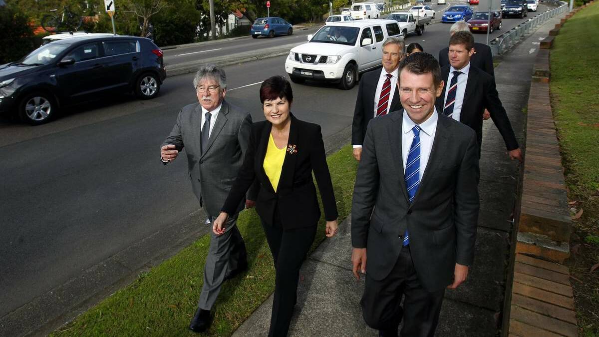 FUNDS: In Newcastle yesterday, from left, Swansea MP Garry Edwards, Maitland MP Robyn Parker, Newcastle MP Tim Owen, Premier Mike Baird, and Charlestown MP Andrew Cornwell. Also obscured at the back are Minister for Transport and the Hunter, Gladys Berejiklian, and Port Stephens MP Craig Baumann.   Picture: Max Mason-Hubers