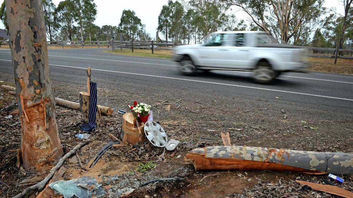 TRAGIC: Tributes are left amid the remnants of Jake Hain’s car accident at Pokolbin. Mr Hain died in the crash on Wednesday.