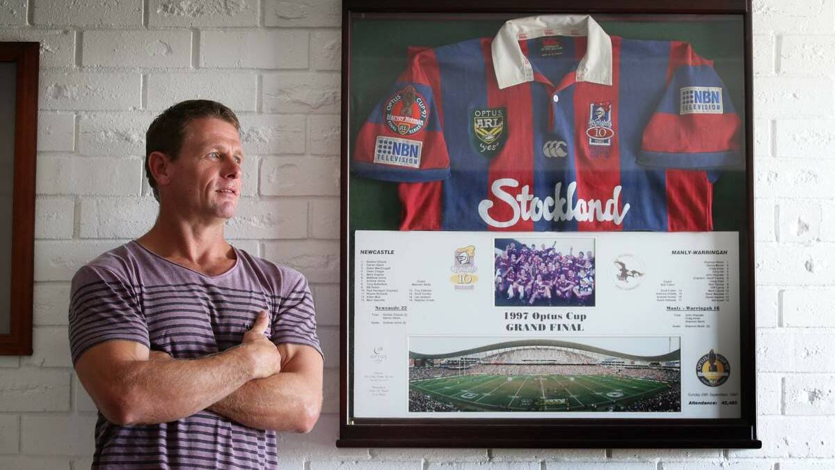 PRIZED POSSESSION: Bill Peden at home yesterday with the Knights jersey he wore in the 1997  grand final.  Picture: Dean Osland