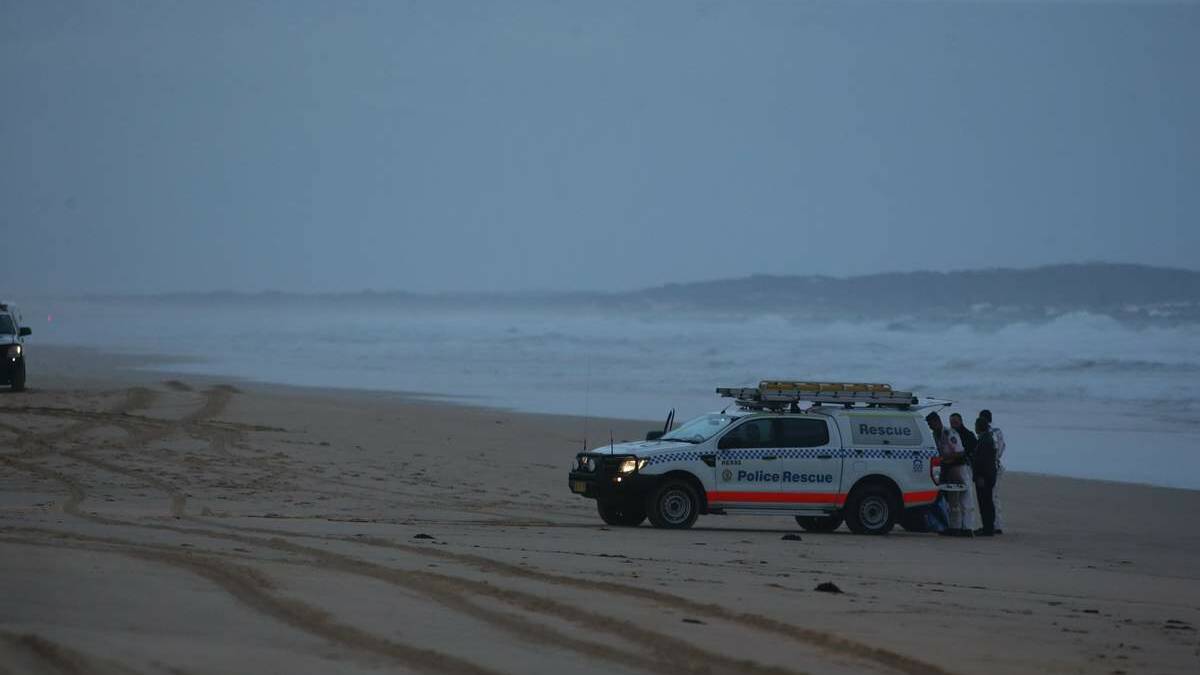 Police on Stockton beach on Friday evening after the bodies were found washed ashore.
Picture: Peter Stoop