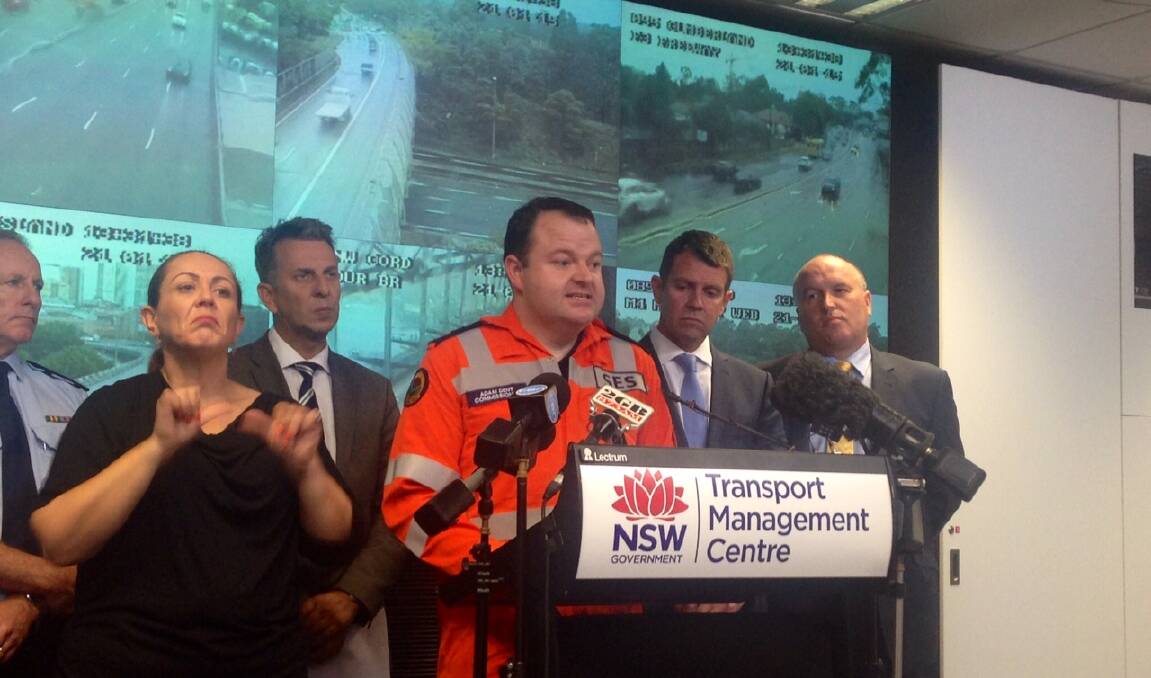 SES Commissioner Adam Dent with Premier Mike Baird, Emergency Services
minister David Elliott and Transport minister Andrew Constance address
the media at the Transport Management Centre in Sydney about the wild
weather. Picture: Michelle Harris