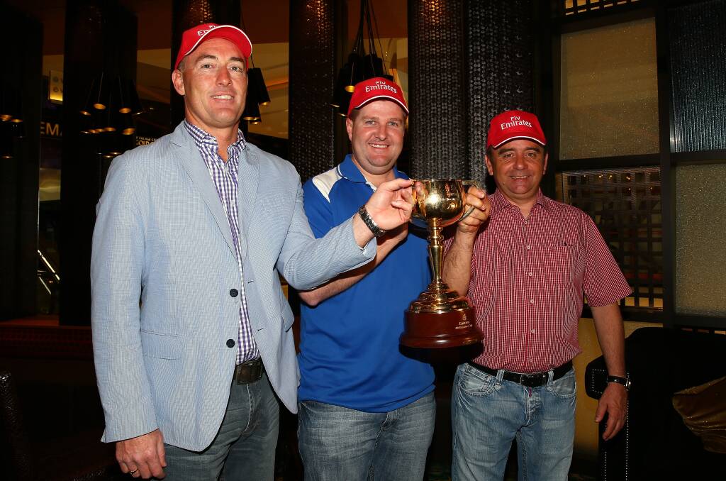 Winners: Jamie Lovett and Luke Murrell, pose with the Melbourne Cup and winning trainer Andreas Wohler.