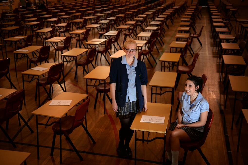 ONE DOWN: St Francis Xavier’s College  students  Olivia Anderson,  16,  and Ashleigh Duggan,  17, are all smiles after their English exam.  Picture: Marina Neil