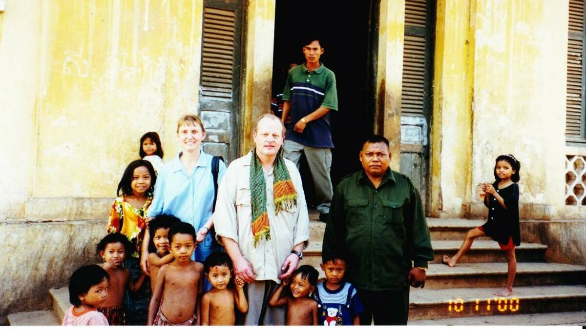  Dr Ross Dyer pictured here with children at a hospital in Cambodia.
