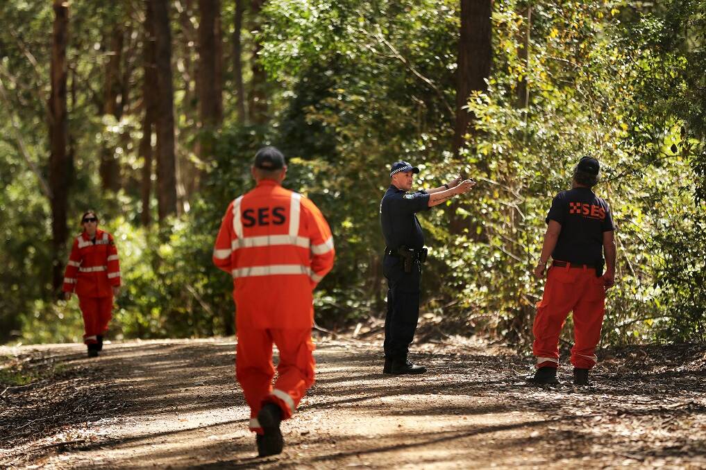 NSW police officer senior constable Jarred Cutler (2nd from right) directs SES volunteers searching along Haydons Road in the Middle Brother State Forest approximately 12km from Kendall looking for any clothing or signs of 3 year old William Tyrell.

