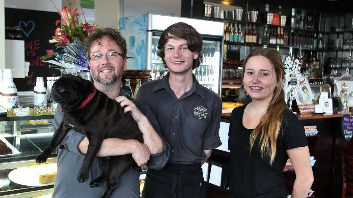 COME IN: Fredric Holten, holding pug Pookie, with staff members Luke Brunner and Emily Bourke. 