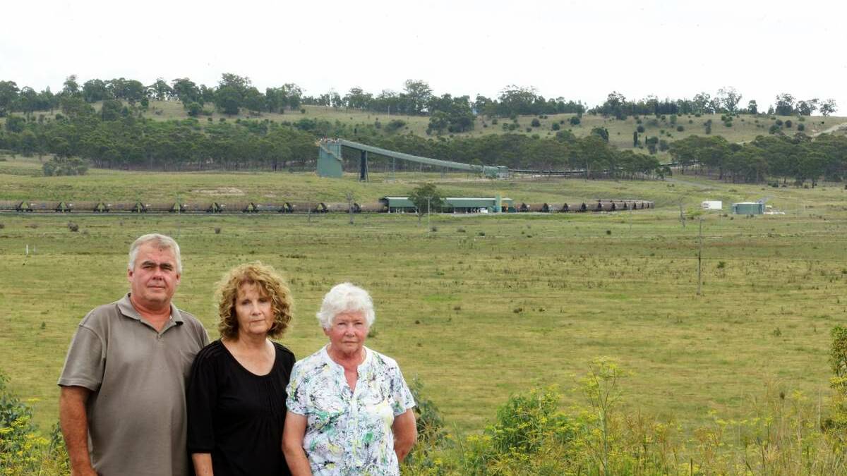 WEATHER AND NOISE: Peter and Julie Brown with Peter's mother June  near Mangoola mine with the mines rail loop visible in the background . Picture: Peter Stoop