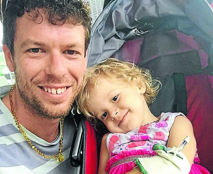 ARRESTED: Brisbane father Adam Koessler with daughter Rumer, 2, who is living with cancer. 