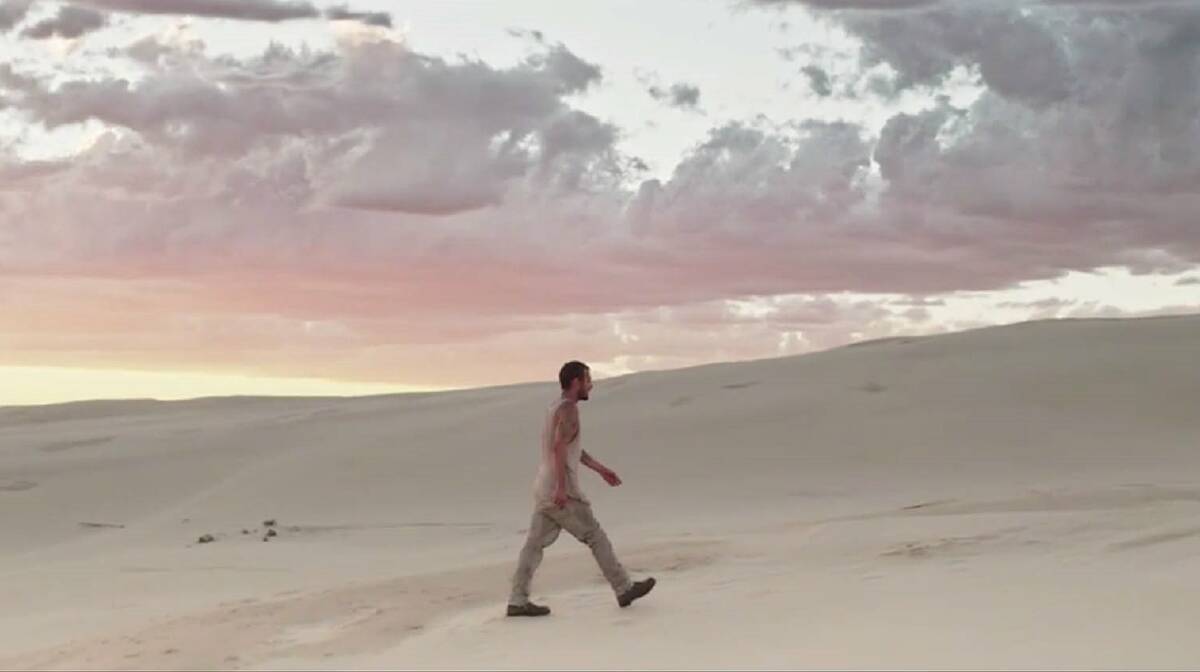 Johns walks through Stockton dunes in the Aerial Love clip.