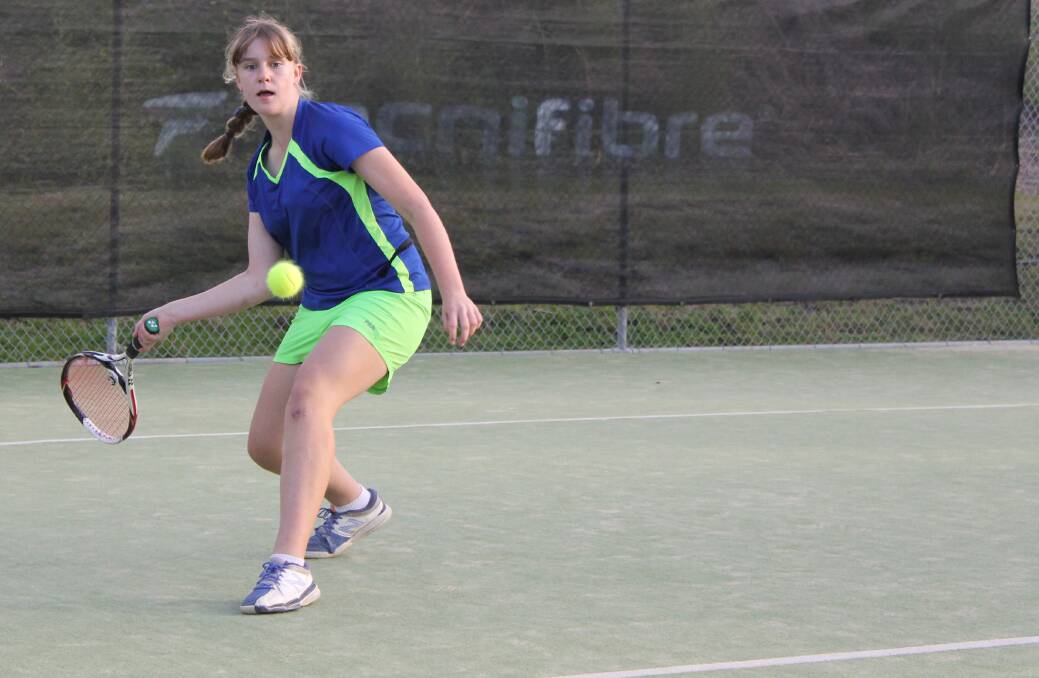 Sarah Jenkins, 12, in action at  Lake Macquarie Tennis Centre.
