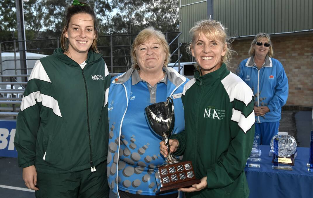 CROWNED: Newcastle's captains Kim Williams and Narelle Eather receive the Pat Weston OAM Trophy from Netball NSW board member Carol Murphy. Picture: Nigel Owen/Netball NSW