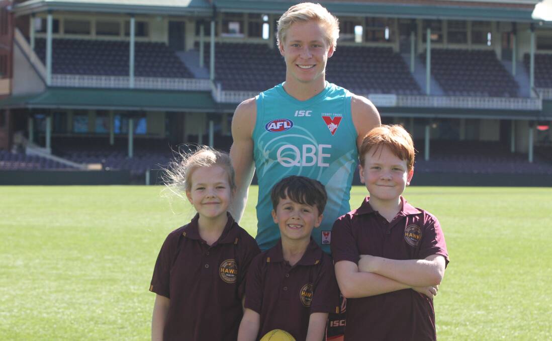 PAYING BACK: Swans star Isaac Heeney spent the morning with Cardiff Hawks juniors Rose Williams, Lucas Gray and Taj Williams, showing them the Sydney Cricket Ground. Picture: Michelle Cooling