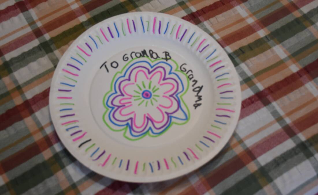 BEAUTIFUL GIFT: A decorative plate created by eight-year-old Brittliffe Close fire victim Bayley Atkins for her great-grandfather Johnny on Thursday. 