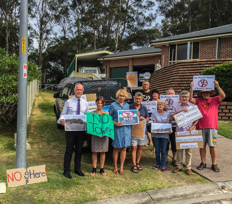 Anger: Lake Macquarie councillor Colin Grigg with Caves Beach residents opposed to the tower. 