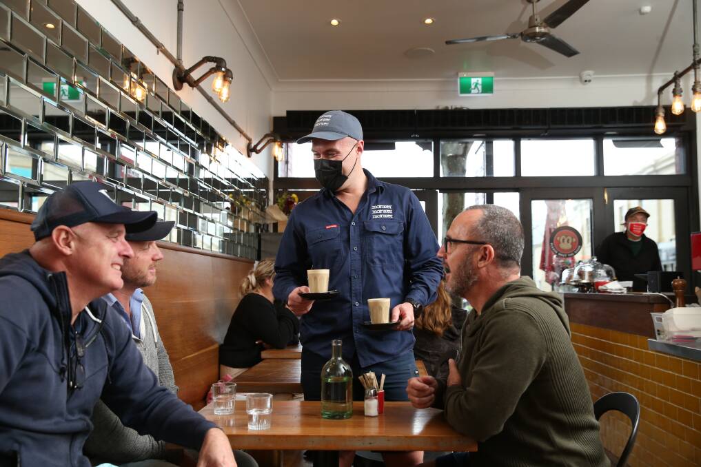 Brothers Mike, Jimmy and Ant Strachan being served by Nic Williams at Three Monkeys on Monday. Picture: Marina Neil