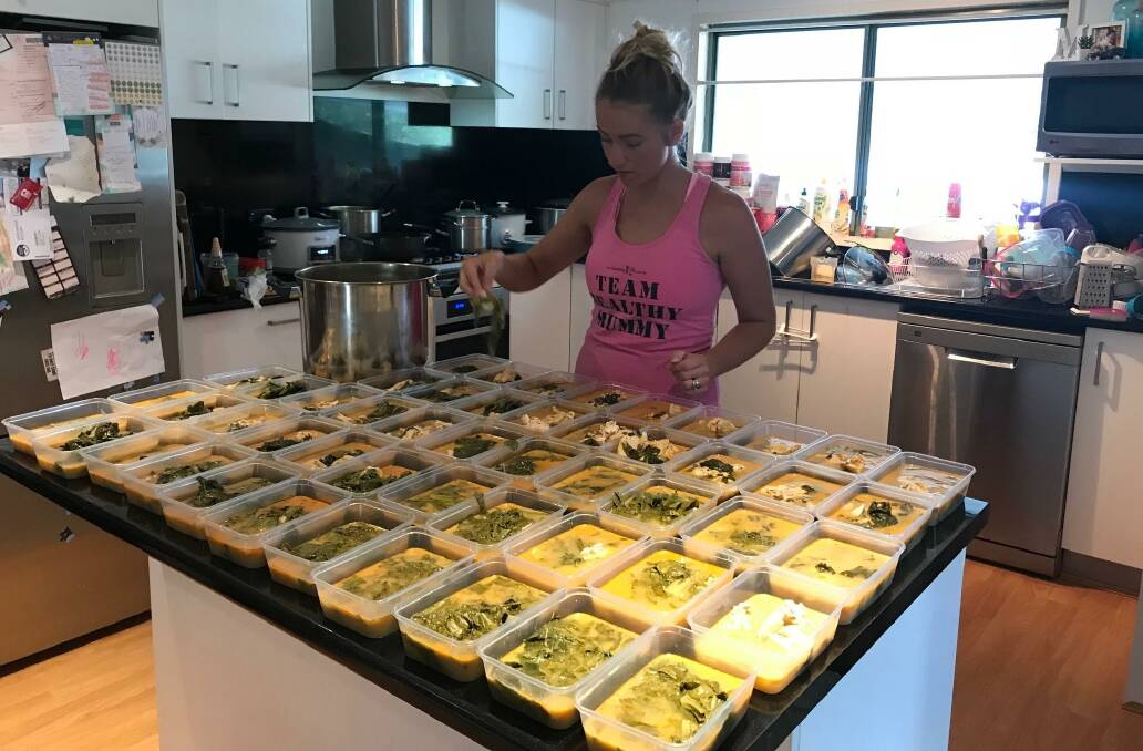 On a roll: Lake Macquarie mum-of-two Kaitie Purssell working hard in her kitchen to prepare 250 meals on Thursday.