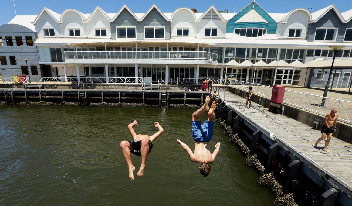 Flippin' warm: A couple of young swimmers about to make a splash in the harbour on Wednesday. Picture: Jonathan Carroll