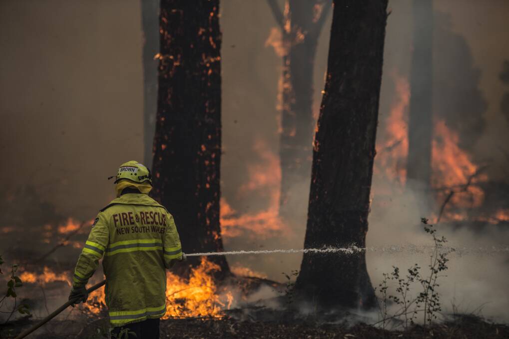 A firefighter works at the scene of a blaze at Taree on the weekend. Picture: Wolter Peeters