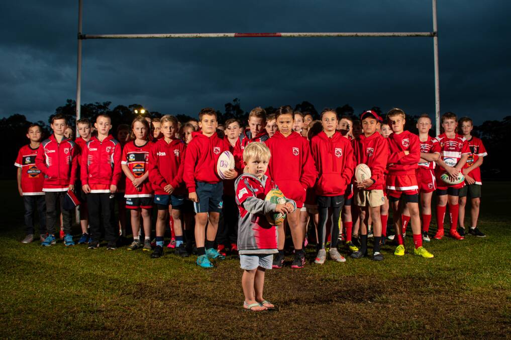 A group of Valentine Eleebana Devils with three-year-old Alby Withyman at the front - whose older brother Lennox plays in one of the U10 teams. Picture: Simon McCarthy