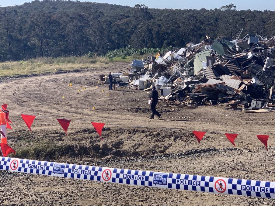 Aftermath: Forensic police survey the scene inside Cessnock Waste Management Centre, where a 54-year-old man suffered fatal injuries.