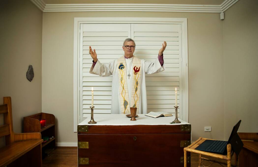 Different times: Anglican Bishop of Newcastle Peter Stuart at his home, where he will live-stream Easter services from his laptop this weekend. Picture: Marina Neil
