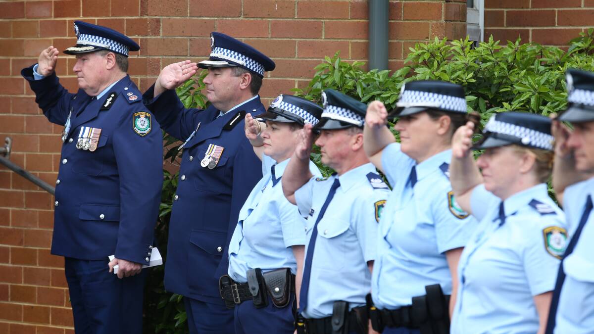 Police, including Deputy Commissioner Jeff Loy (far left) form a guard of honour at John 'Bopper' Mooney's funeral. Picture: Marina Neil
