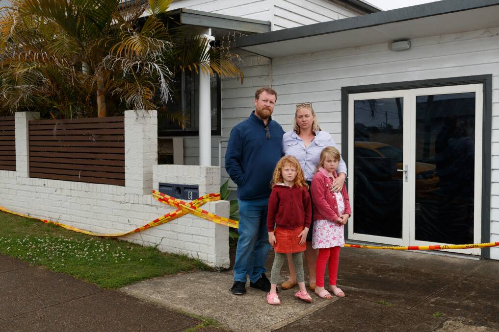 The Mansfield family - Jeff and Jannah and their daughters Juliana and Mikhayla - outside their burnt home damaged when a Thai restaurant caught fire at Kurri Kurri last month. Picture by Max Mason-Hubers