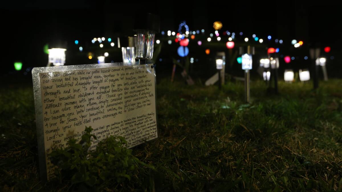 Friends and strangers have left solar lights with messages and prayers on their front lawn. Picture: Simone De Peak