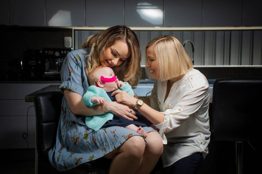 Poppy Grace Middleton with her parents Carly and Tresne in late 2021. Picture by Simon McCarthy