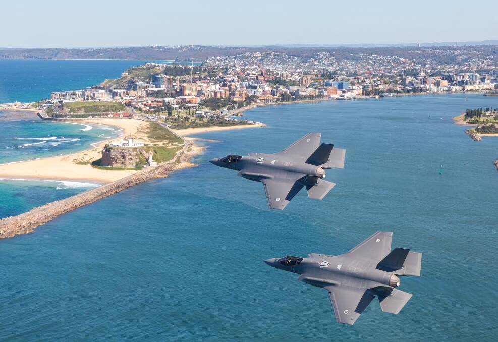 Two jets soar about the entrance to Newcastle harbour. Picture by Royal Australian Air Force Sergeant David Gibbs