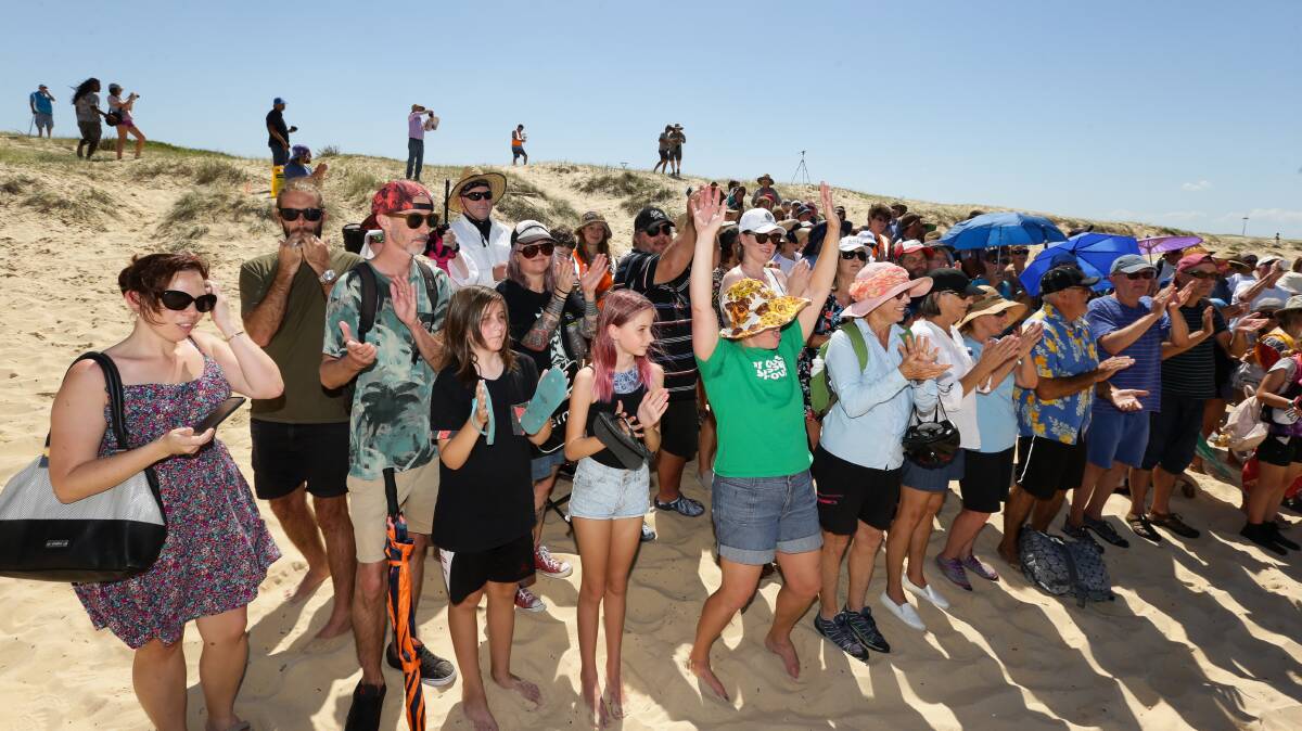 Hundreds of people gathered at Nobbys Beach on March 18 to protest against a plan for seismic testing off the coast of Newcastle. Pictures: Jonathan Carroll