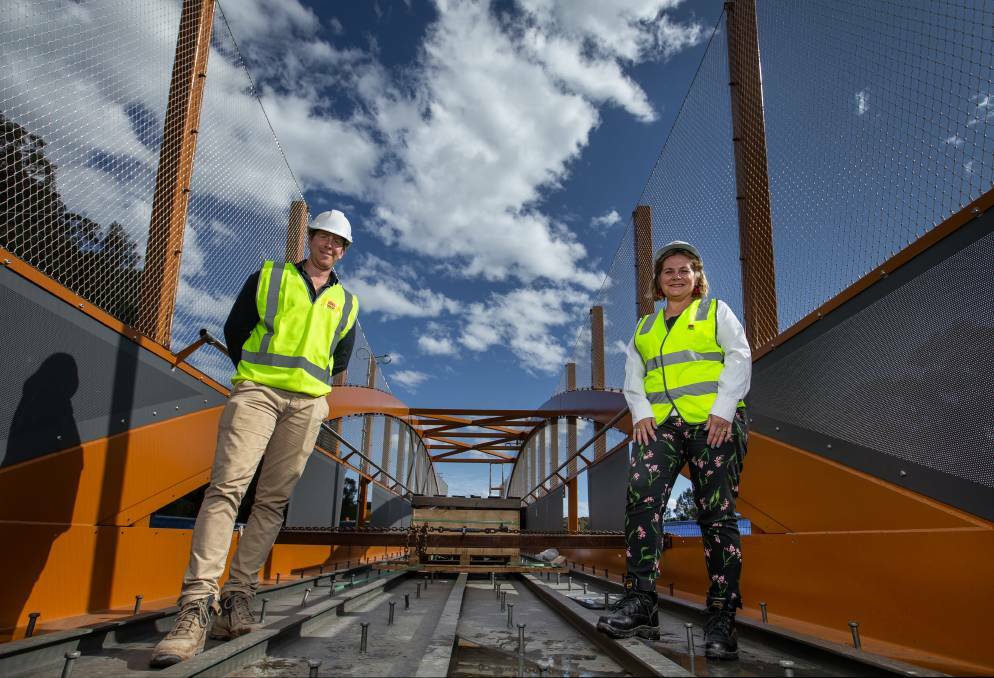 Project officer Michael Edwards with Transport for NSW regional director Anna Zycki standing on the bridge span in Jesmond in October. Picture: Marina Neil