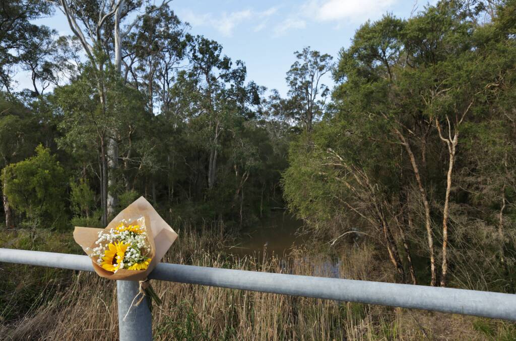 Tribute: Flowers left at a bridge over Cockle Creek on Monday, where Danielle Easey's body was found on Saturday. Picture: Simone De Peak