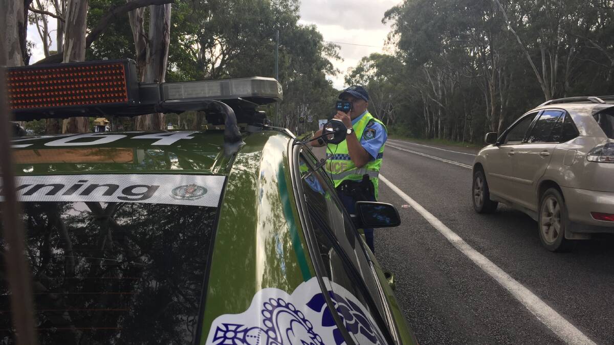 Speed check: A police officer during a previous crackdown at Lake Macquarie.