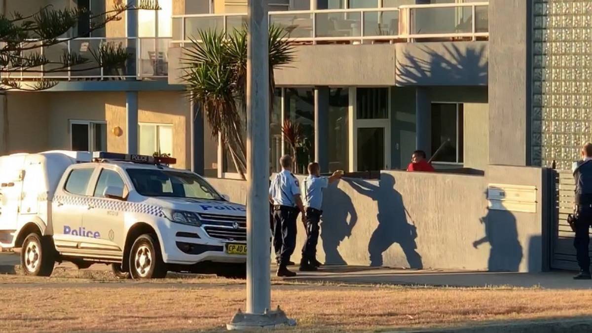 Attack: An image of the stand-off captured by a bystander at Bar Beach. John Peter Collins is now waiting to be sentenced.