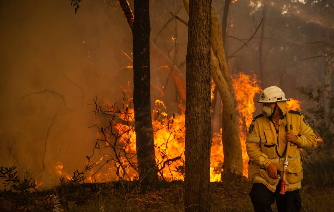 A firefighter works on a blaze at Charmhaven on the Central Coast on New Year's Eve. Picture: Marina Neil