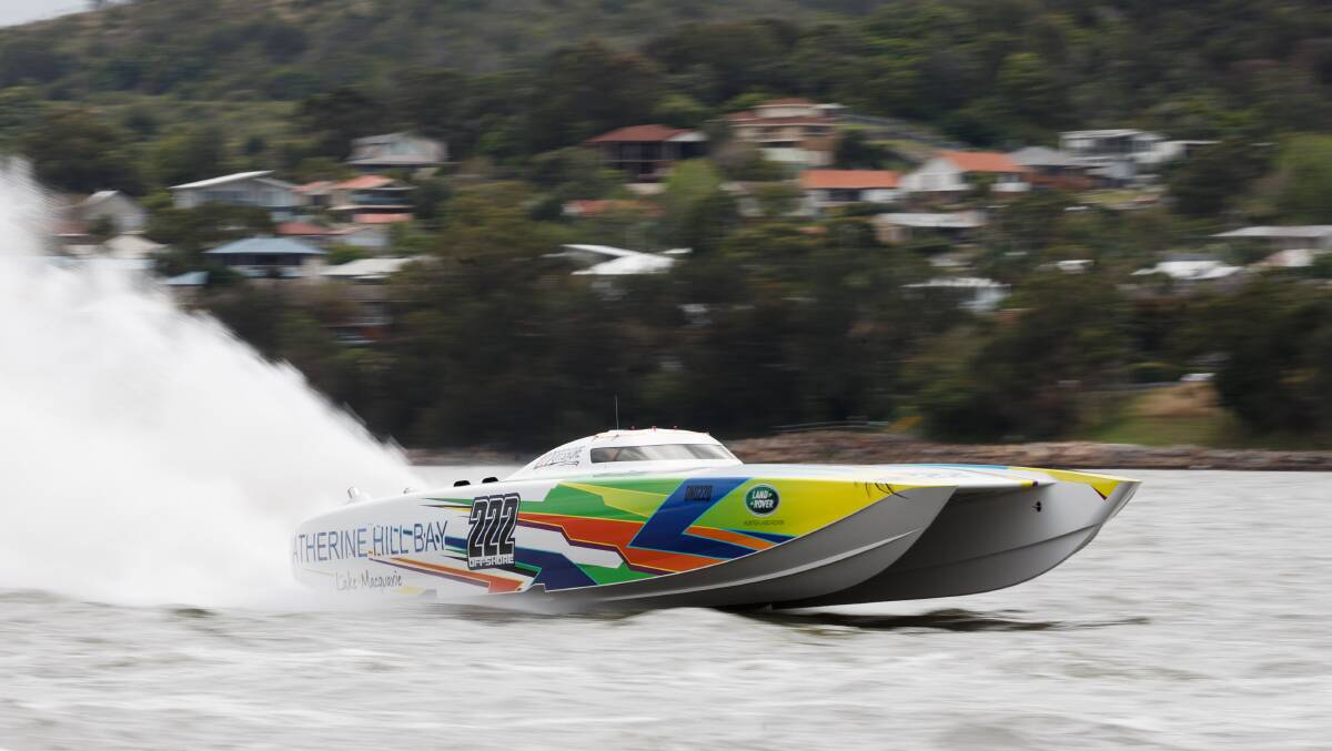High speed: Darren Nicholson’s superboat tears through the water with Lake Macquarie mayor Kay Fraser at the wheel on Thursday. Picture: Max Mason-Hubers