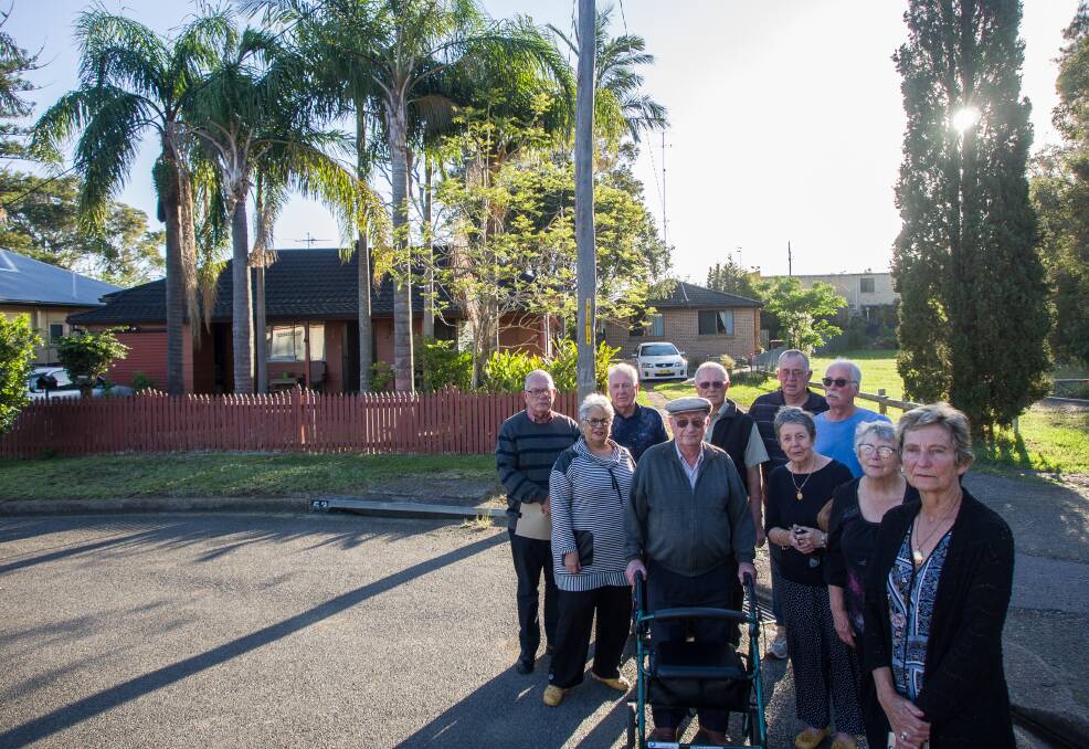 Concerned: Warners Bay resident Irene Lojszcyk with fellow Albert Street residents at the site of the proposed units.