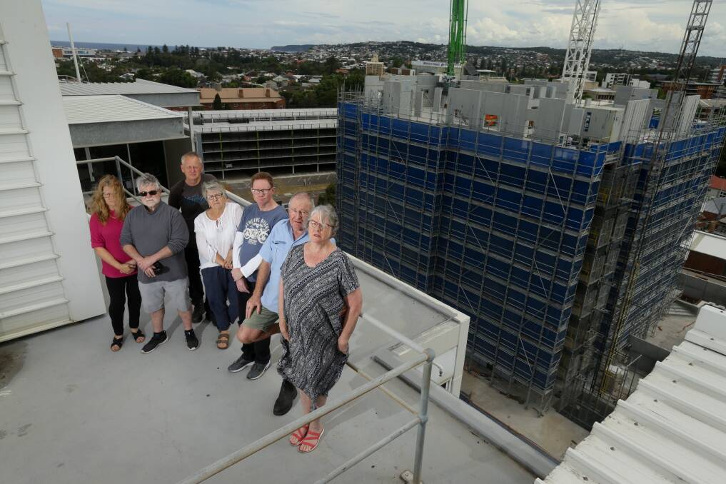 TUNNEL VISION: Vicki Morante, in red, with neighbours on the Worth Place Apartments roof. If approved, two towers would be built between them and the blue-clad Sky Residence, now about half its final height. Picture: Jonathan Carroll