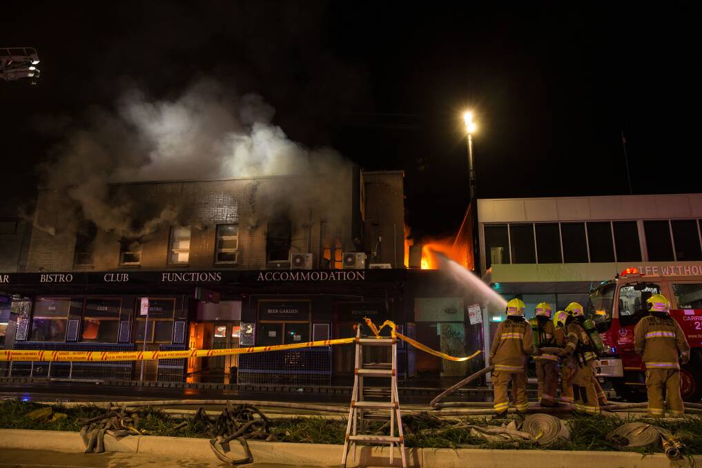 Firefighters at the burning former pub on Sunday night. Picture: Marina Neil